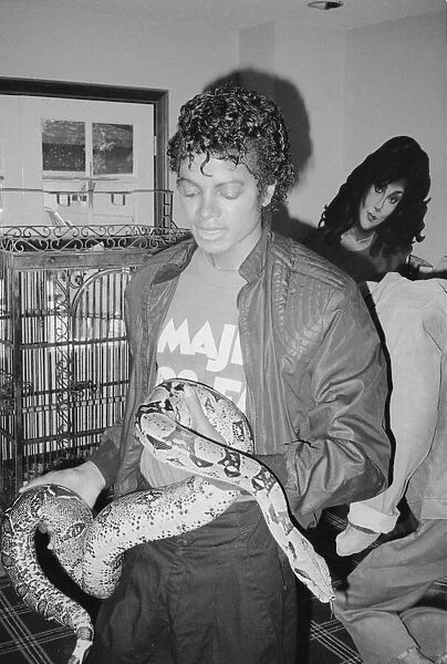 Singer Michael Jackson with his pet Muscles the boa constrictor at his home in California