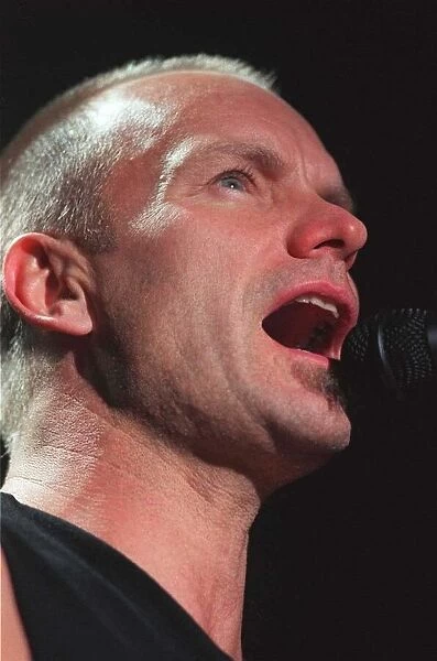 Sting rock singer performing live on stage in Aberdeen with mouth open singing into