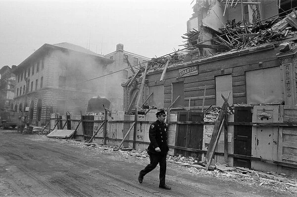 Street scene in New York, a policeman walking past as a building is being demolished