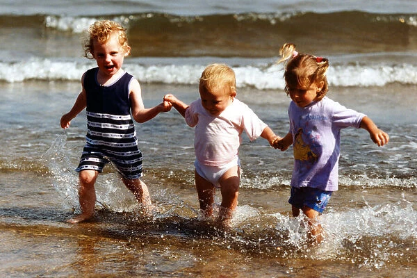 Summer Weather Scenes - Sunbathing Sisters Ellie Woodhead, 3, (stripes), Katie, 2