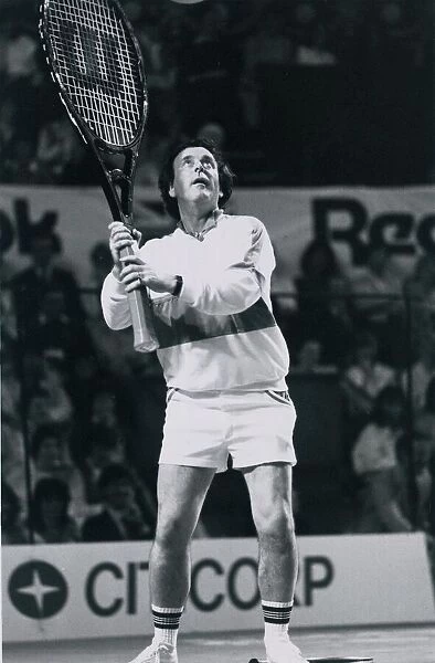 Television presenter and chat show host Terry Wogan playing tennis with a giant racket