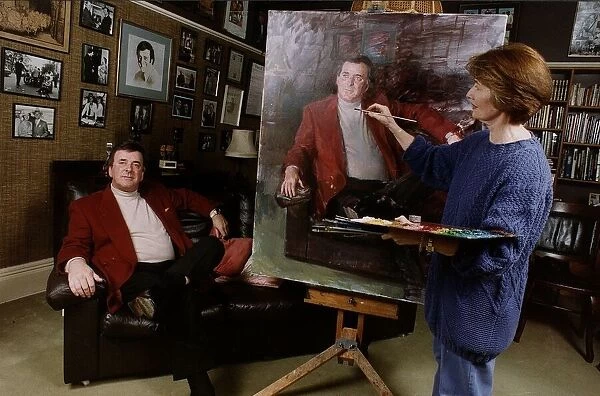 Terry Wogan TV Presenter sits patiently while artist June Mendozo paints his portrait