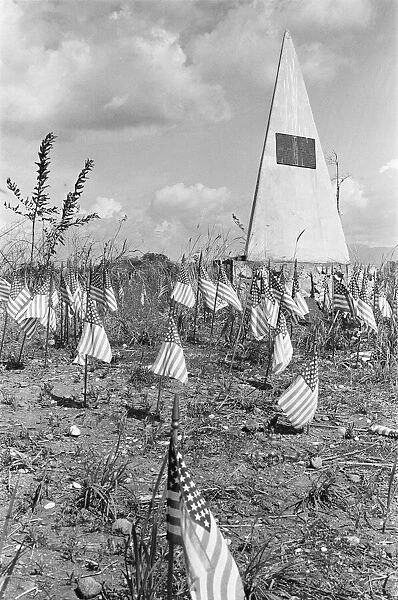 Th U. S. Marine memorial surrounded by miniature American flags on 'Bloody Ridge