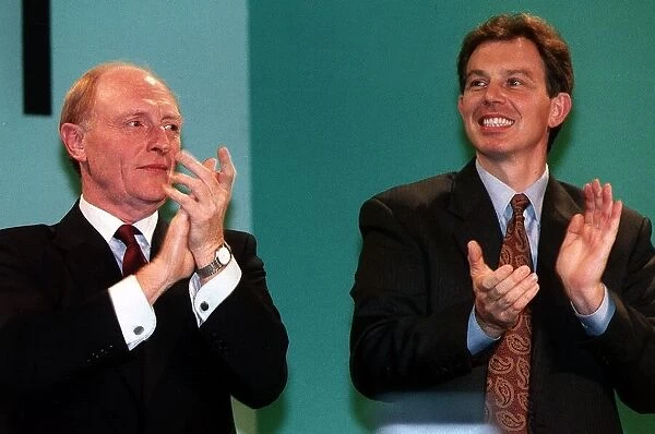 Tony Blair with Neil Kinnock clapping together