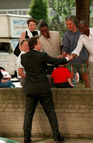 Tony Blair visits council estate in London June 1997 Shakes hands with residents during