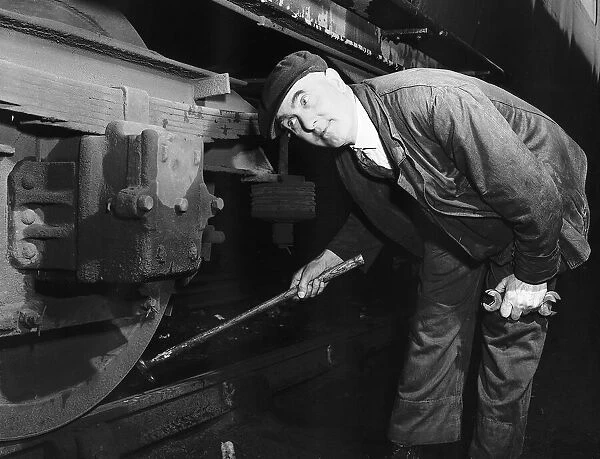 Wheel Tapper Bill Warden seen here walking the length of his train checking the wheels