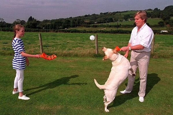 William Roache Actor playing with his daughter and their dog in the back garden