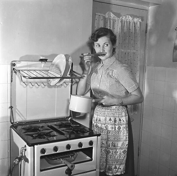 Woman in kitchen. Circa 1952
