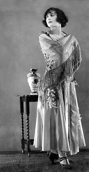 Woman wearing a long elegant patterned dress July 1925 P008634