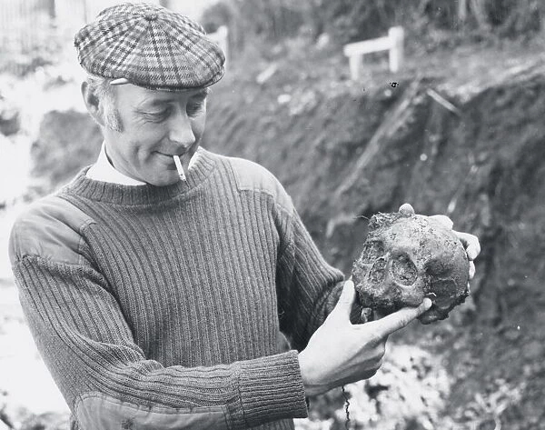 A workman with the skull uncovered when building the new Herald Express office on Barton
