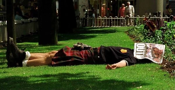 World Cup France June 1998 Scotland fan asleep lying in St Etienne garden with Daily