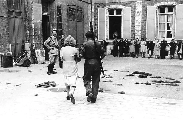 WW2 - A woman collaborator is led to the prefecture courtyard in Chartres
