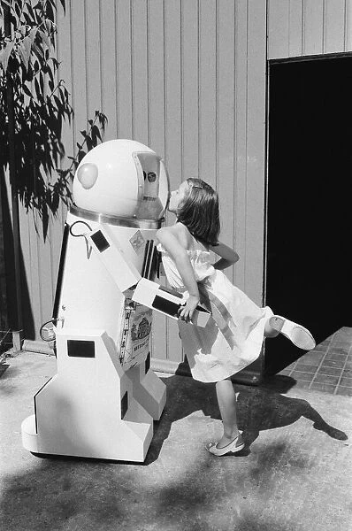 Young Admirer Helen Dobbie, 8 years old from Hove, kisses, Denby the robot, which talks