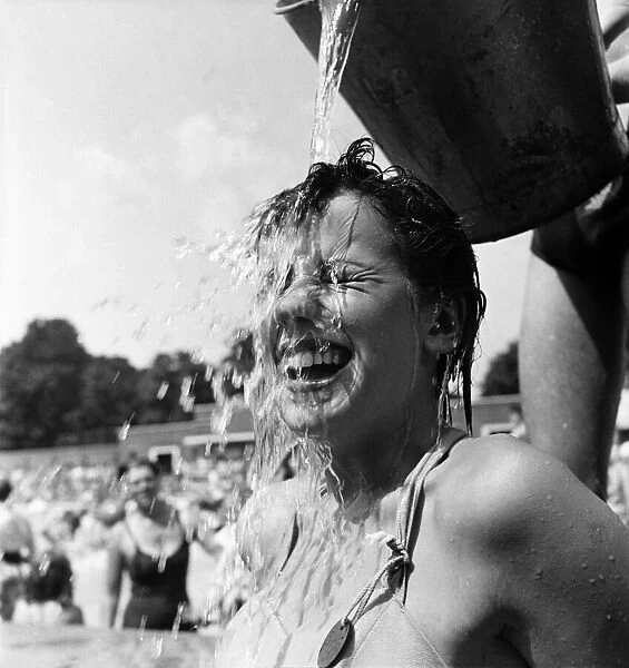 Young girl keeps cool during the hot weather. July 1952 C3326