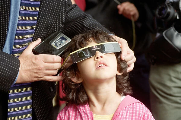 A young girl watching the solar eclipse in Chester. 11th August 1999