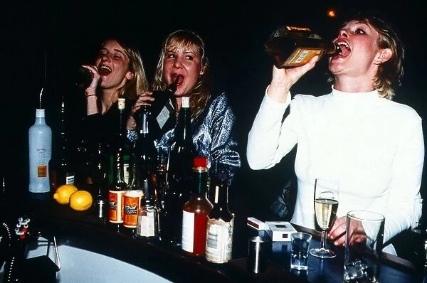Young Women drinking straight from the bottle in a Bar - January 1996 Girls