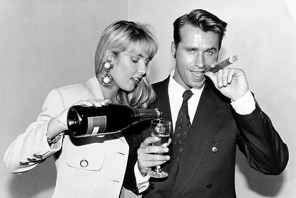 Yuppie couple drinking champagne and smoking cigars