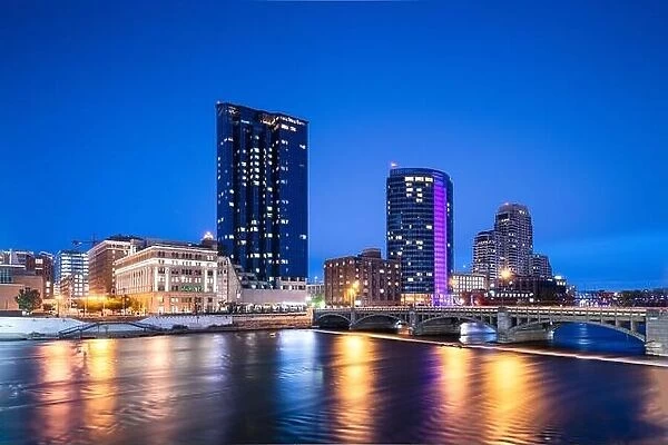 Grand Rapids, Michigan, USA downtown skyline on the Grand River at dusk