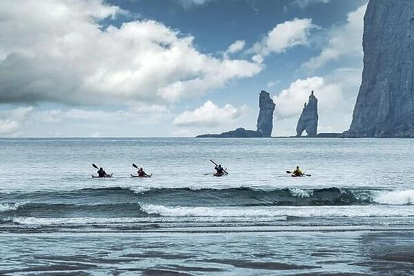 Four kayaker on Tjornuvik beach on Streymoy island, Faroe Islands, Denmark. Landscape photography