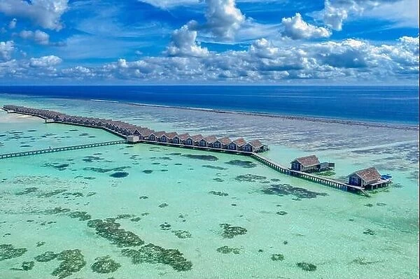 Maldives paradise island. Tropical aerial landscape, seascape, water bungalows villas pier with amazing sea lagoon beach. Exotic tourism destination
