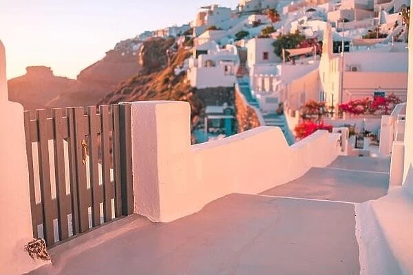 Santorini island sunset view. Architectural details, famous travel destination abstract closeup view of streets in warm sunset light. Wooden gate door