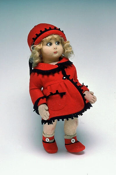 Cloth baby doll, with a red coat and hat, made in the 1920s by the famous Italian firm of Lenci