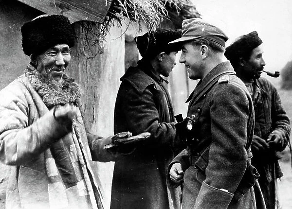 A German army lieutenant talks with a Turkman, during the occupation of Russia. The image dates back to the World War II, during the war between Russia and Germany