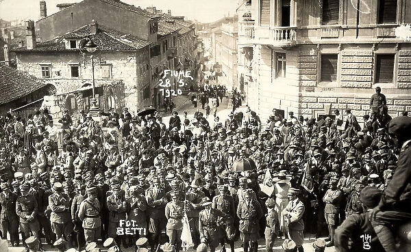 A group of soldiers and civilians in a place of Fiume. The photograph was taken during the occupation of the city by part of the Italian legionary troops, headed by Gabriele D'Annunzio