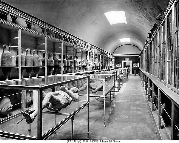 Interior of the second room of the Archaeological Museum of Pompeii with amphorae used to transport wine and the casts of some of the victims of the eruption of Vesuvius in 79 AD found during the excavations. Multi-image