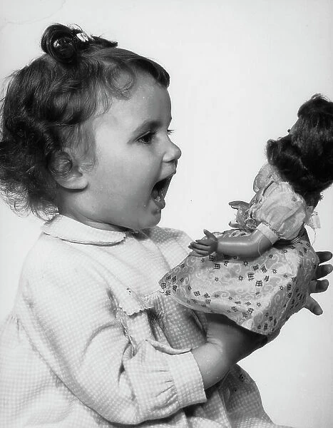 Little girl playing with a doll