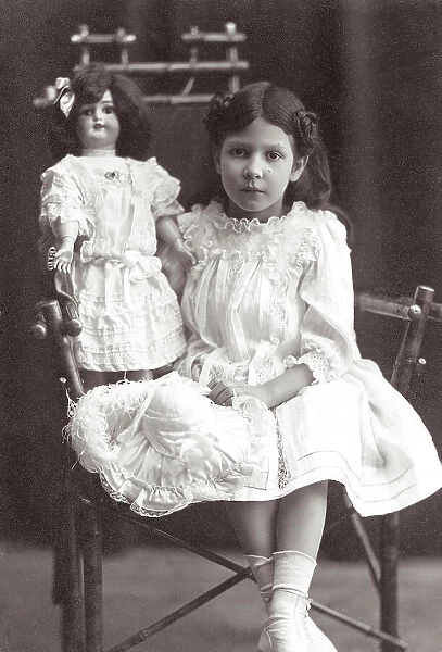 Portrait of a little girl with her doll