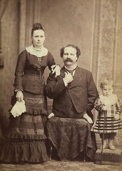 Portrait of a man without legs, with his wife and son