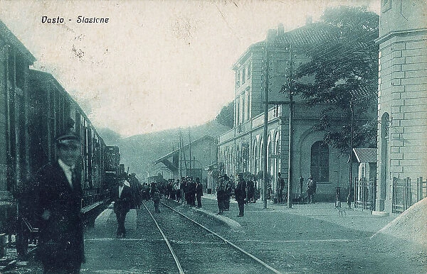 Railway station of Vasto: people waiting near a track while a train runs on the opposite track