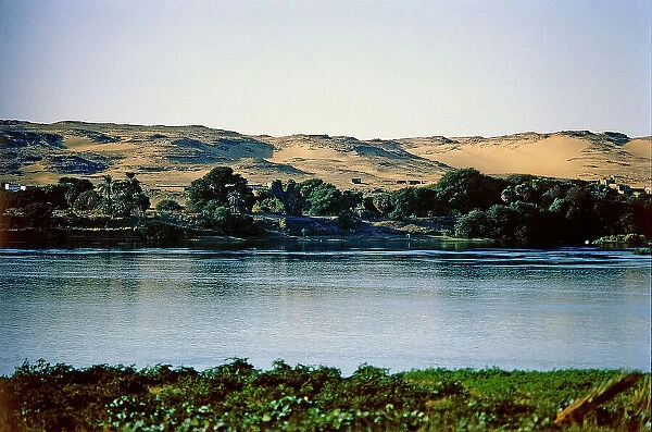The red sands of the desert come to the Nile