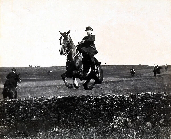 Rider shown jumping over an obstacle during a fox hunt at Tavolato, Rome