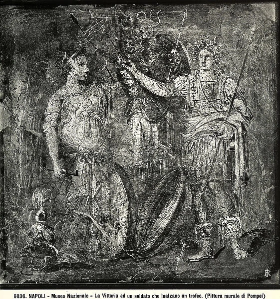 Wall fresco with Victory raising a trophy together with a soldier; work from Pompeii preserved in the National Archaeological Museum of Naples