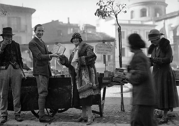 A woman photographed while buying a book at a stall in Scanno