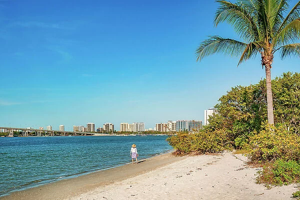 Florida, Palm Beach County, Peanut Island, woman walking on the beach