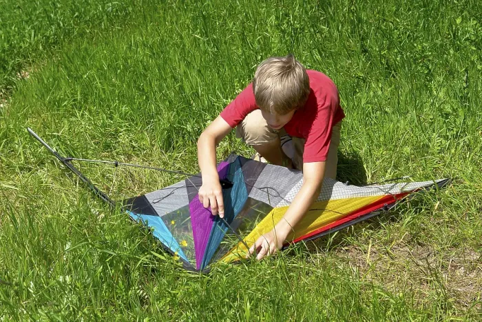 Framed Print : Boy assembles a stunt kite Print Framed Print : Boy assembles a stunt kite Print