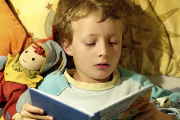Framed Print : Boy reading in bed Print, 19th Century Framed Print : Boy reading in bed Print, 19th Century