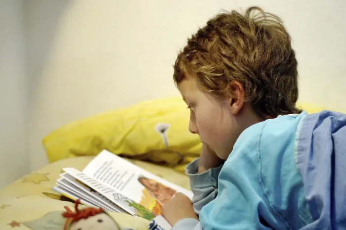 Framed Print : Boy reading in bed Print Framed Print : Boy reading in bed Print