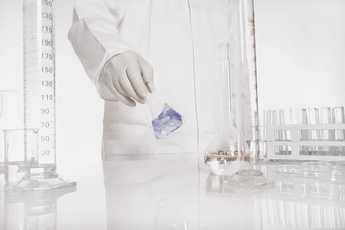 Framed Print : Chemist checking liquid in flask lab Print Framed Print : Chemist checking liquid in flask lab Print