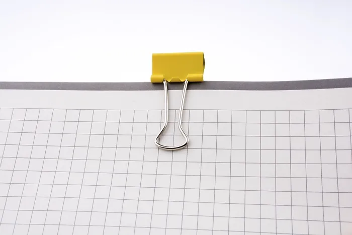 Framed Print : Clip on a Checked Notebook Print