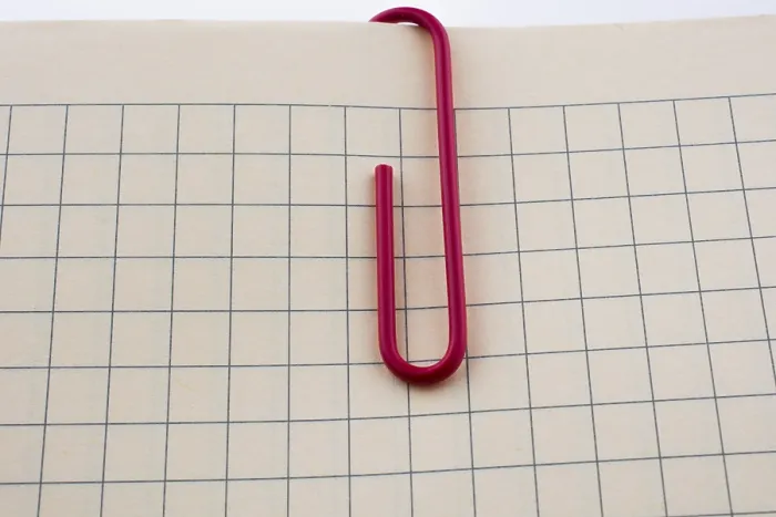 Framed Print : Colored Paper Clip on Checked Notebook Page Print Framed Print : Colored Paper Clip on Checked Notebook Page Print