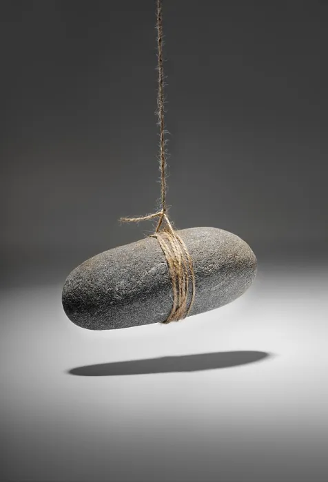 Framed Print : Conceptual Rock on a String Print