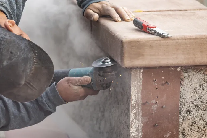 Framed Print : Construction worker using grinder at construction site Print