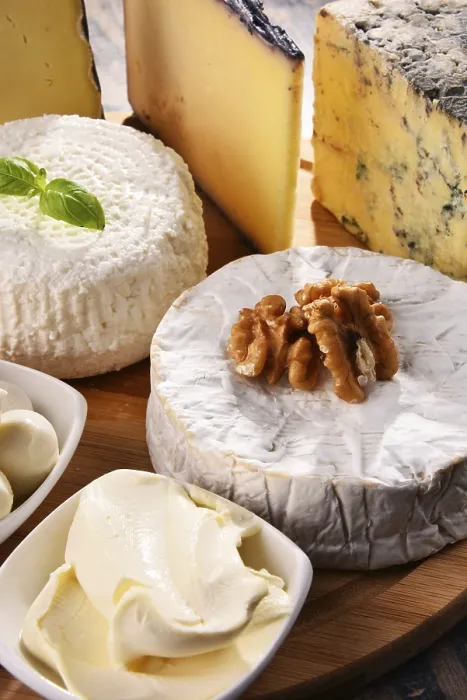 Framed Print : Different Cheeses on Kitchen Table Print