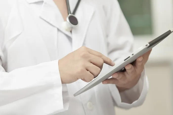 Framed Print : Doctor Working with a Tablet Computer Print