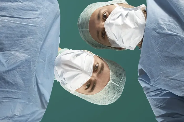 Framed Print : Two Doctors Examine a Patient Print