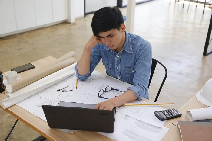 Framed Print : A Focused Architect and Engineer Working on Blueprints Print Framed Print : A Focused Architect and Engineer Working on Blueprints Print